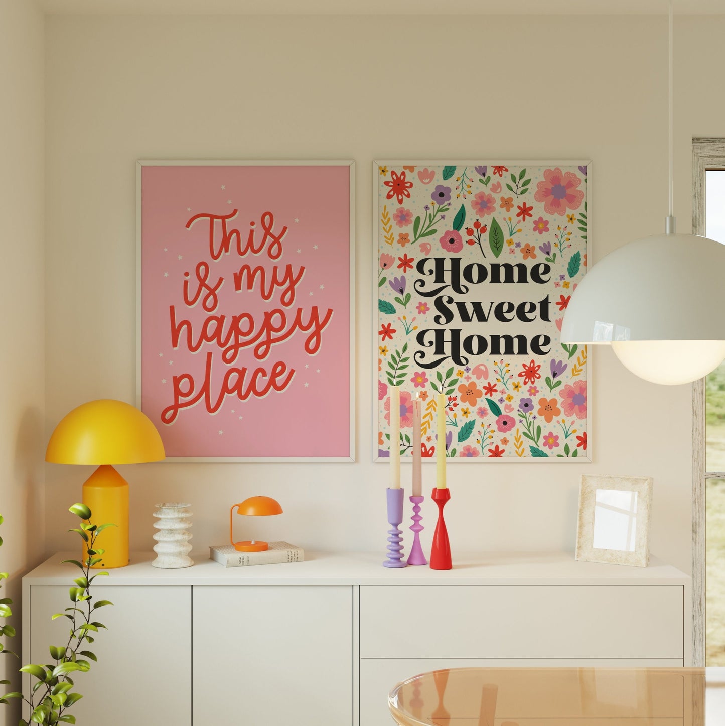 A bright pink print showing fun quote in red text saying this is my happy place. Shown next to a colourful floral print saying home sweet home in the centre.
