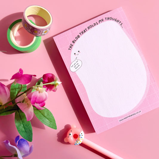 Pink notepad with decorative elements on a pink background