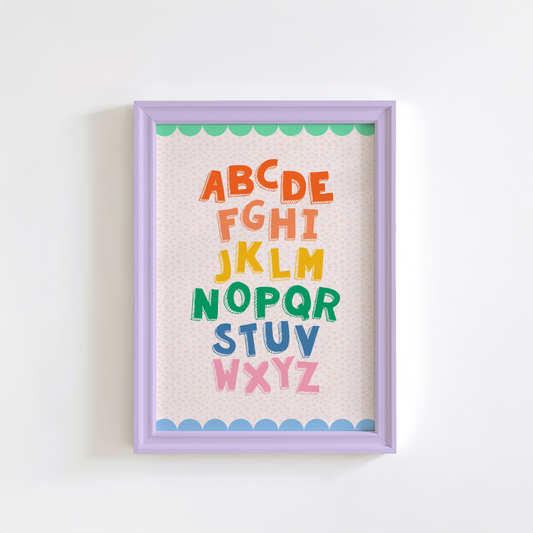 A colourful alphabet print, with a coordinating scallop border, shown in a frame.