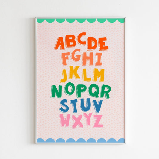 A colourful alphabet print, with a coordinating scallop border, shown in a frame.