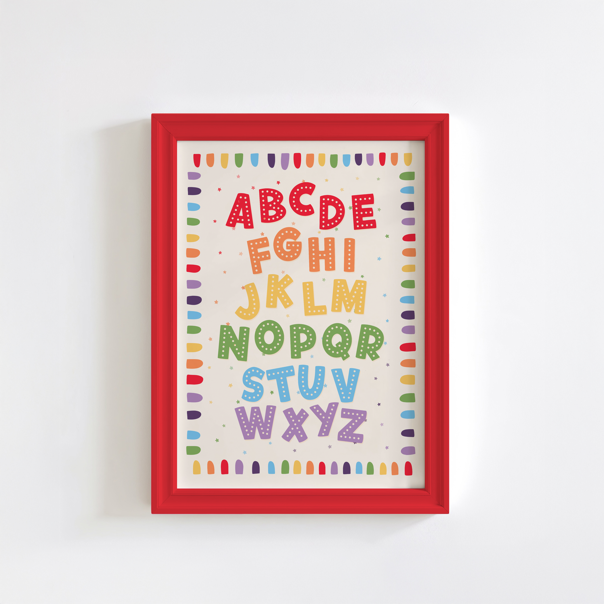 A framed alphabet art print featuring colourful decorative letters A through Z on a cream background, with a decorative border.