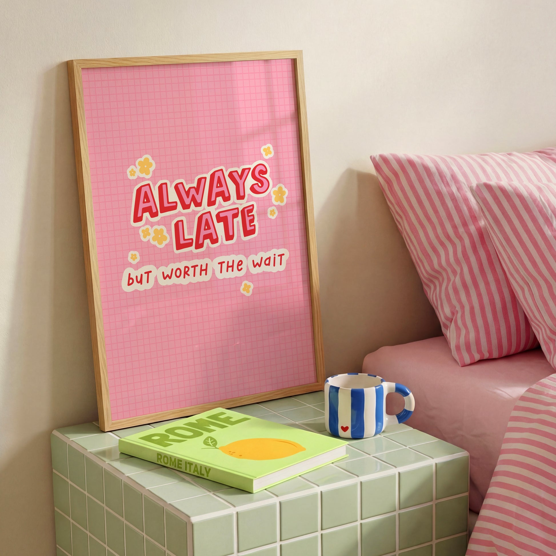 A colourful pink print with a quote saying always late but worth the wait in a contrasting red font.