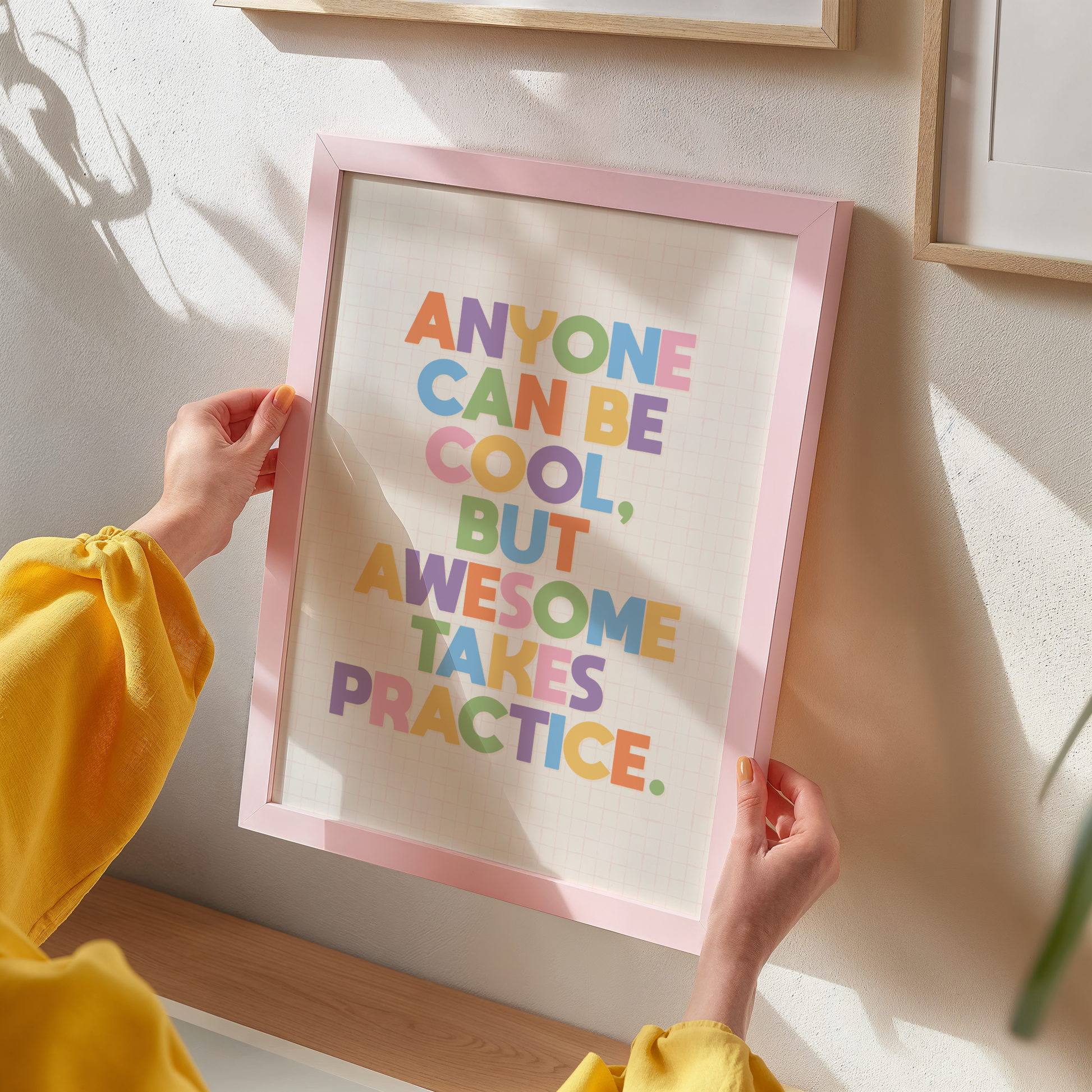 A typography print with a funny motivational quote on, in vibrant colours, shown in a frame.