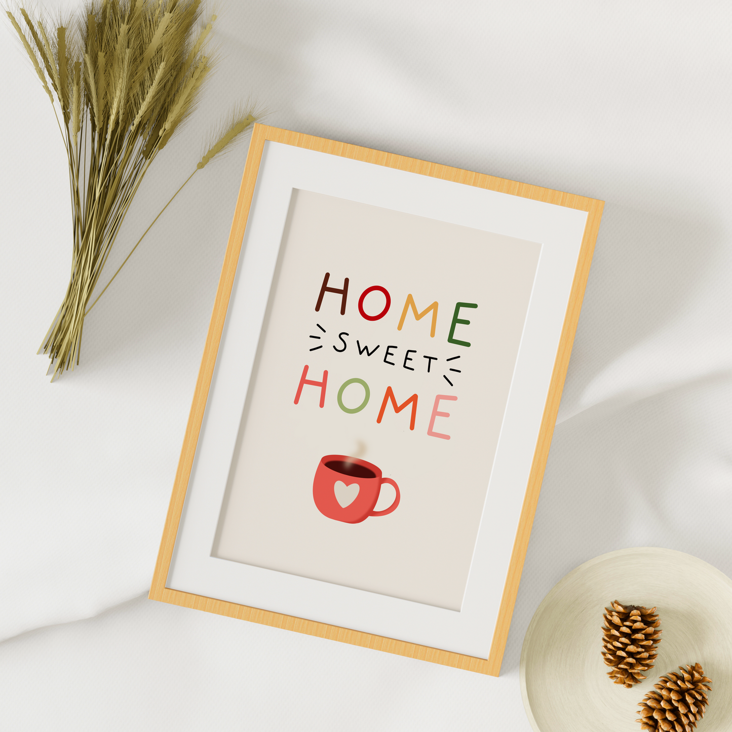 A warm toned print, with the words 'home sweet home' in autumnal colours with a mug illustration at the bottom.