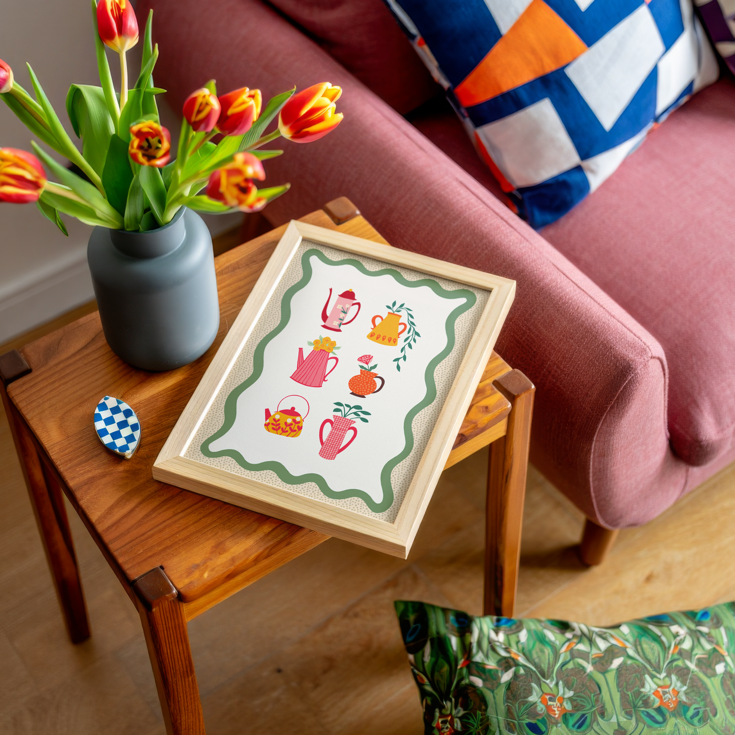 Illustrations of different colourful pots and vases with floral patterns or flowers in them, sat on a cream background with a green wavy border.