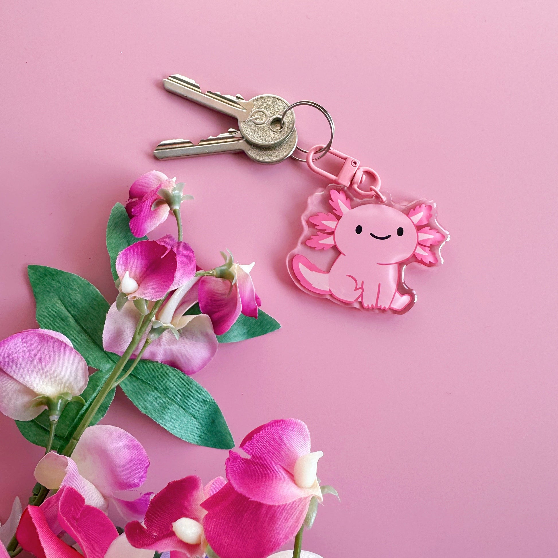 A pink axolotl keyring, with a coordinating pink clasp.