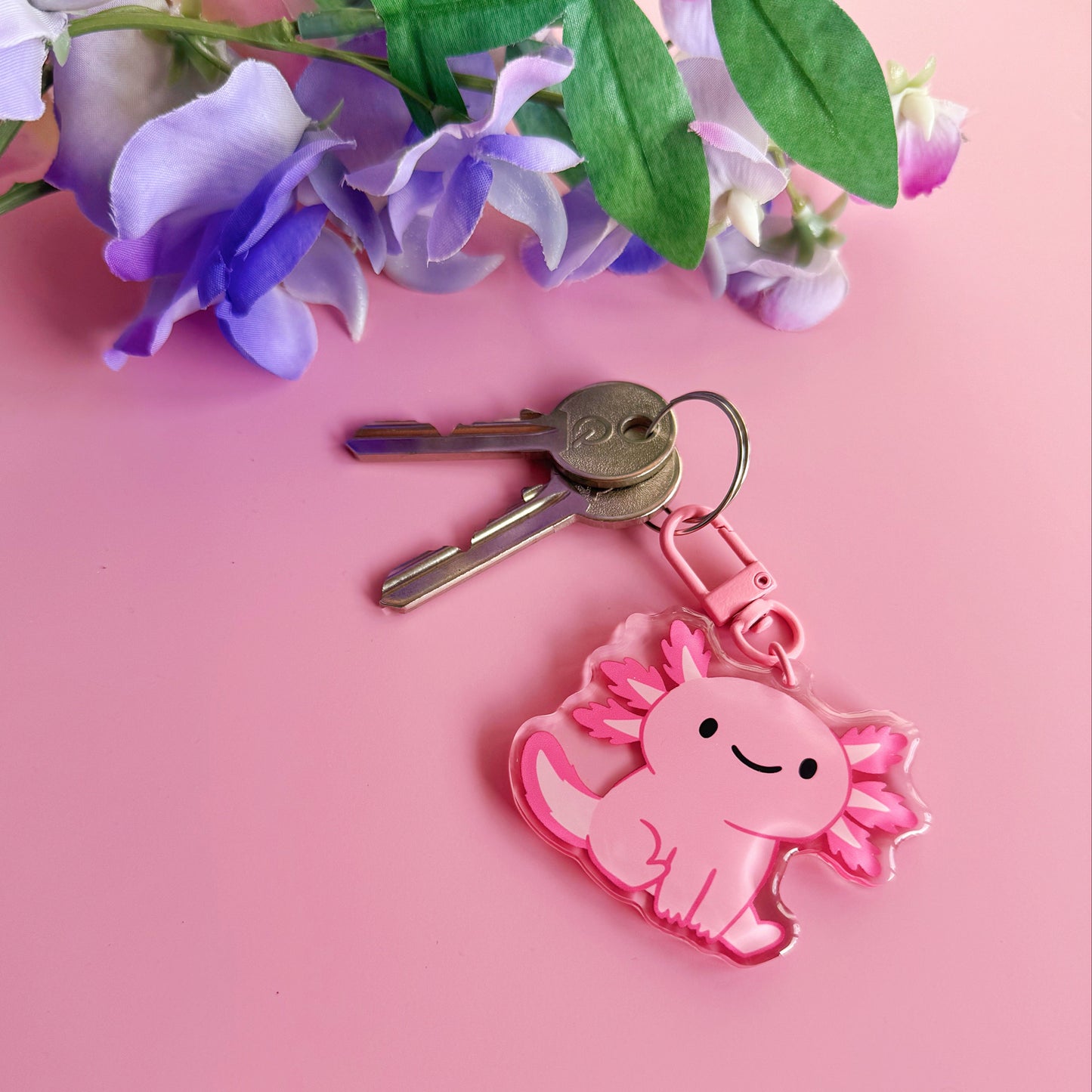 A pink axolotl keyring, with a coordinating pink clasp.