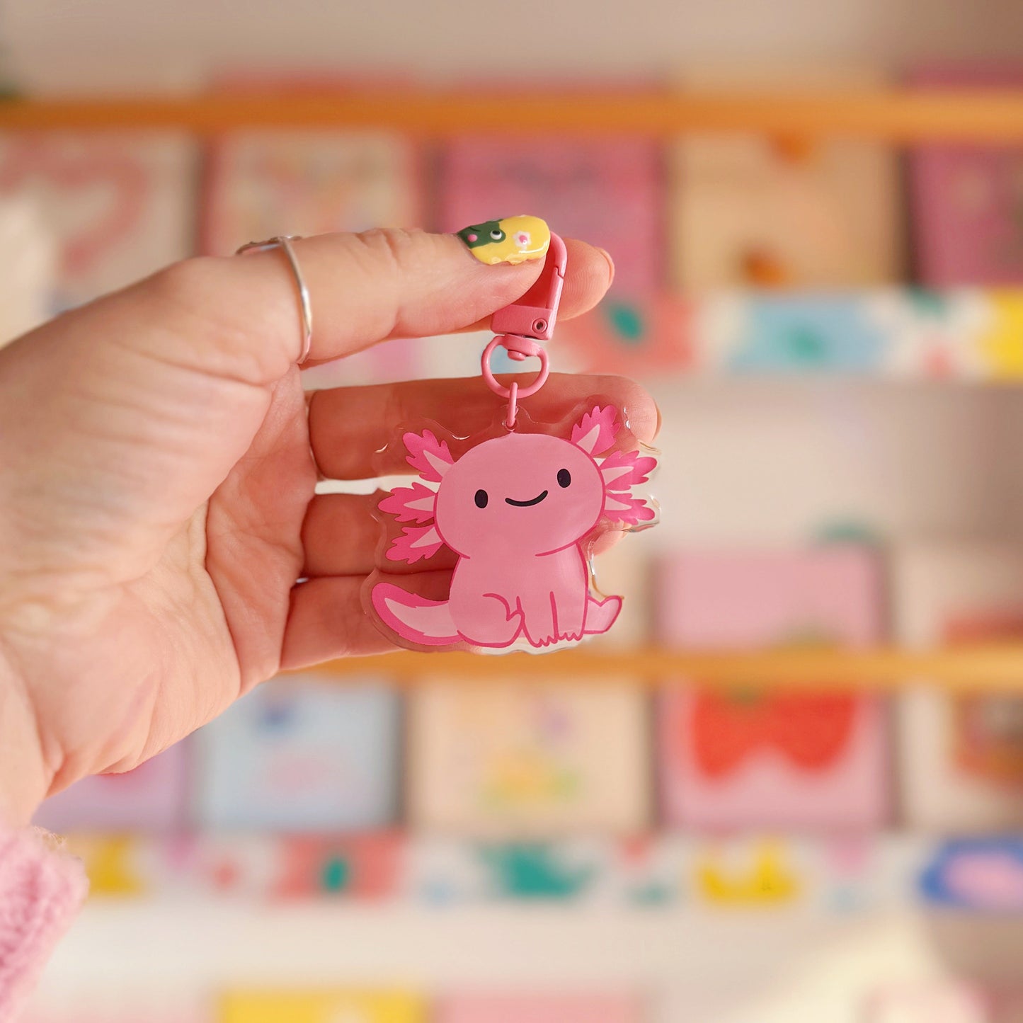 A pink axolotl keyring, with a coordinating pink clasp.