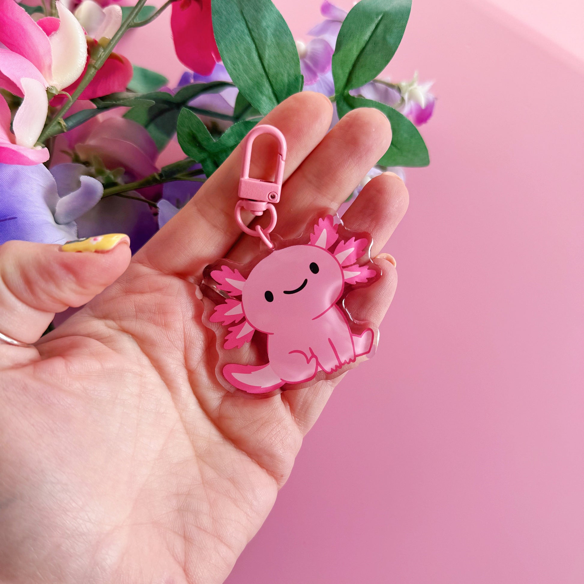 A pink axolotl keyring, with a coordinating pink clasp.