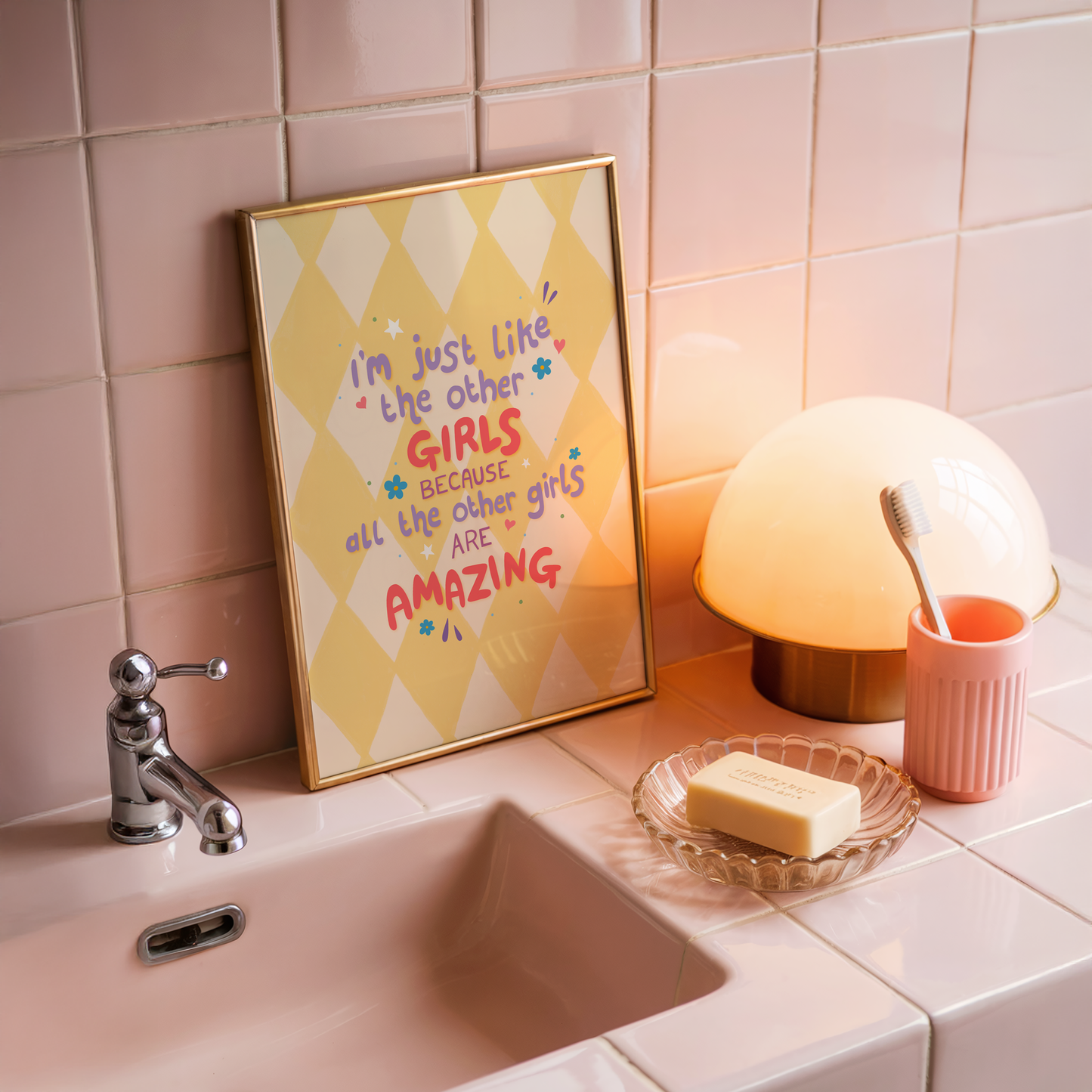 A yellow harlequin patterned background with a female empowerment quote print in different coloured hand lettered text.