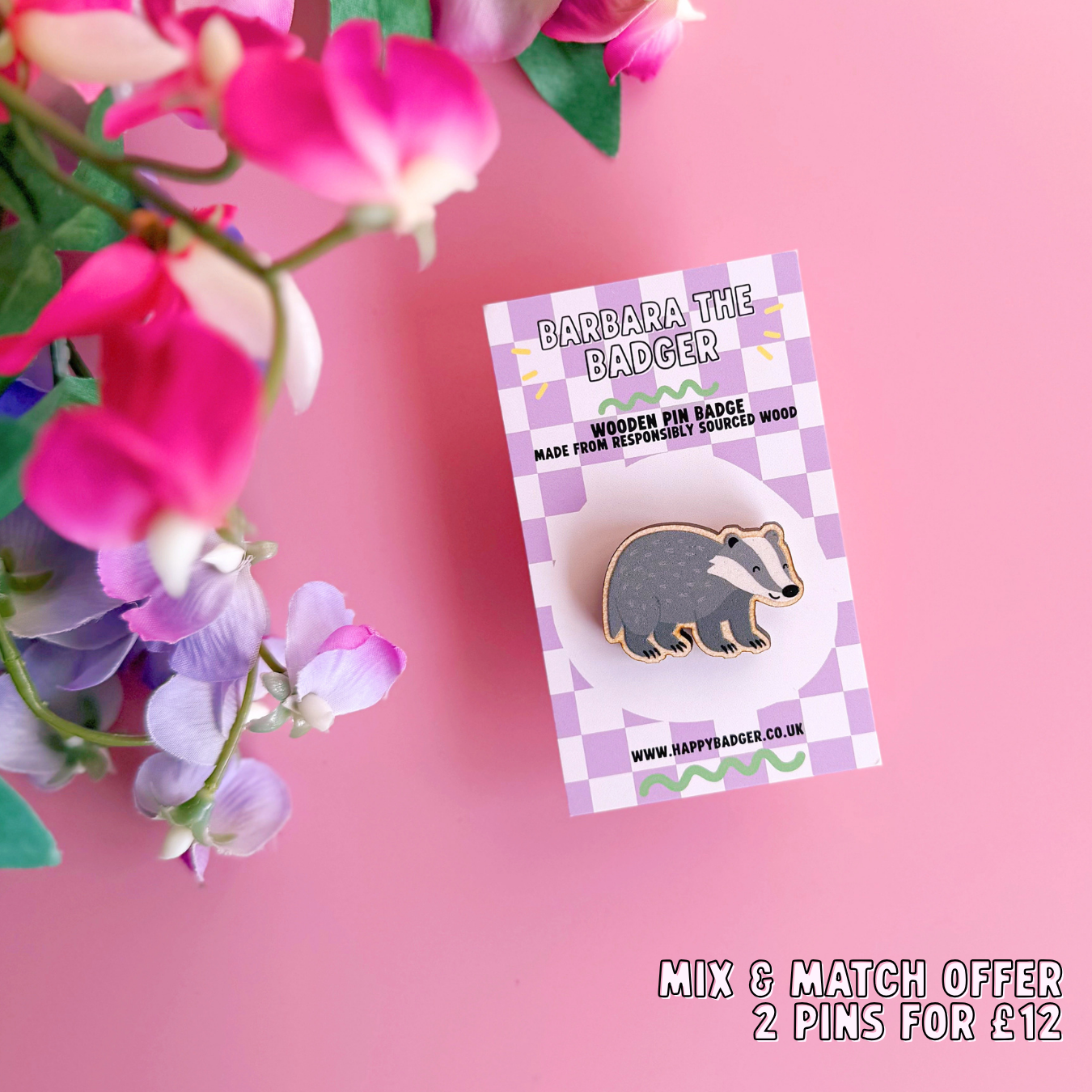 A wooden pin badge with a glossy finish, featuring an illustration of a badger.