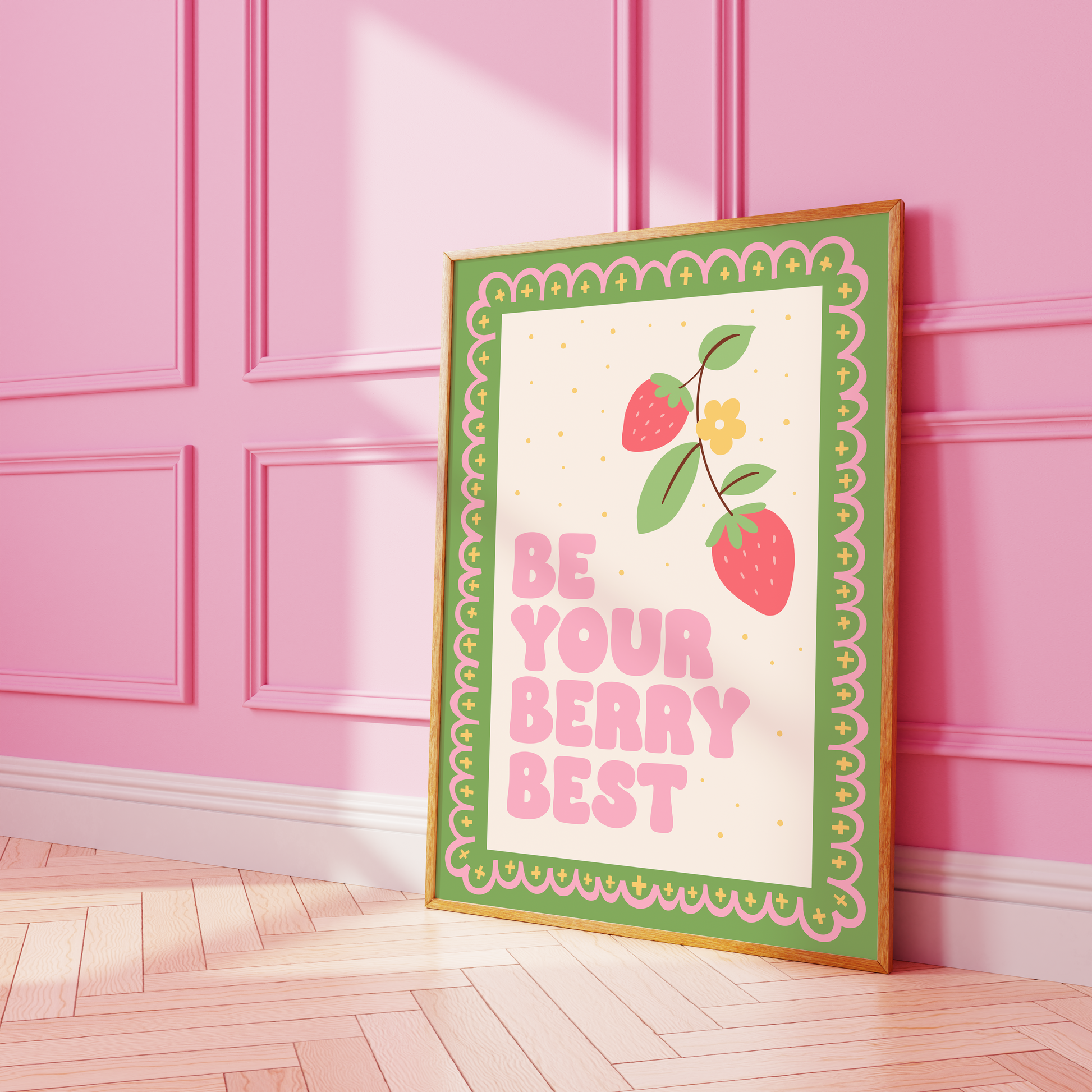 A print with a green and pink illustrated border, and a quote saying 'be your berry best' in a pink chunky font. Next to the quote is an illustration of a strawberry plant.