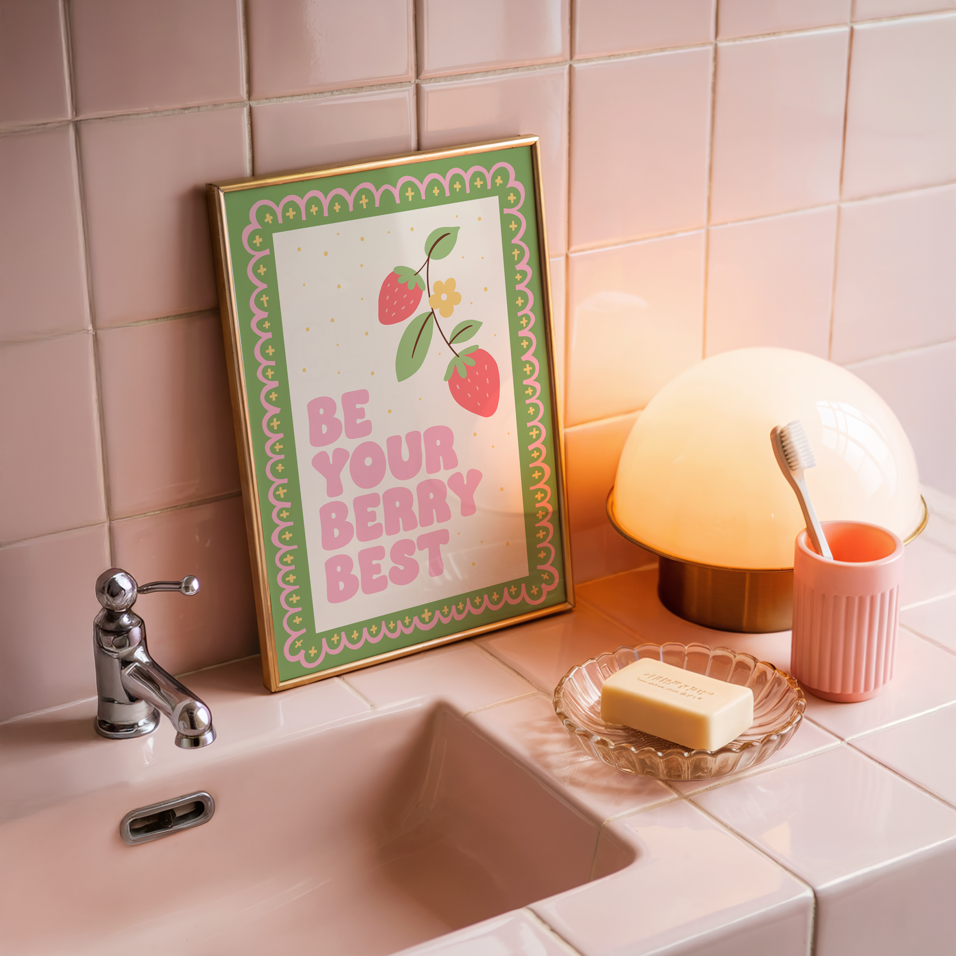 A print with a green and pink illustrated border, and a quote saying 'be your berry best' in a pink chunky font. Next to the quote is an illustration of a strawberry plant.