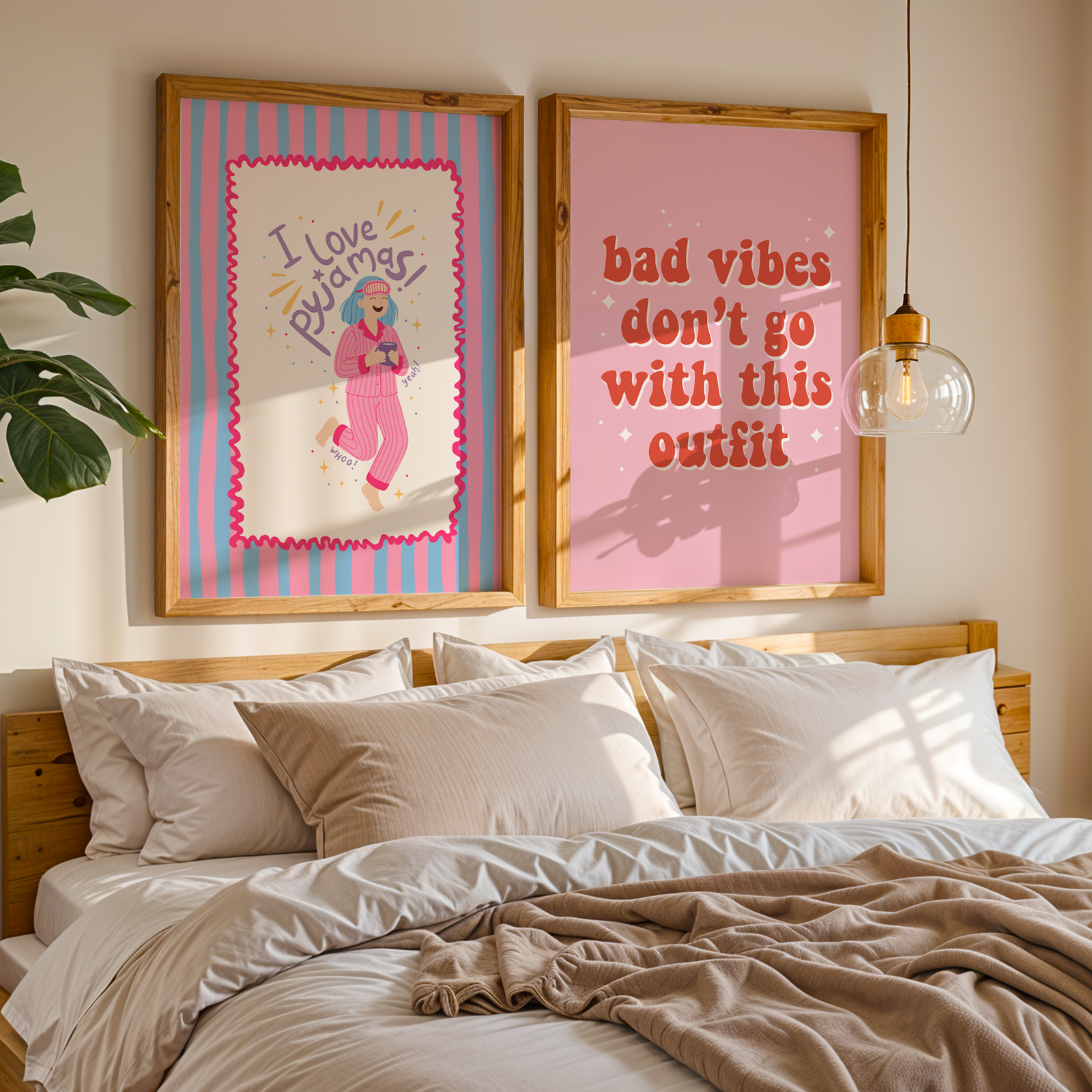 Two colourful prints, one saying  love pyjamas and the other saying bad vibes don't go with this outfit, shown above a cosy looking bed.