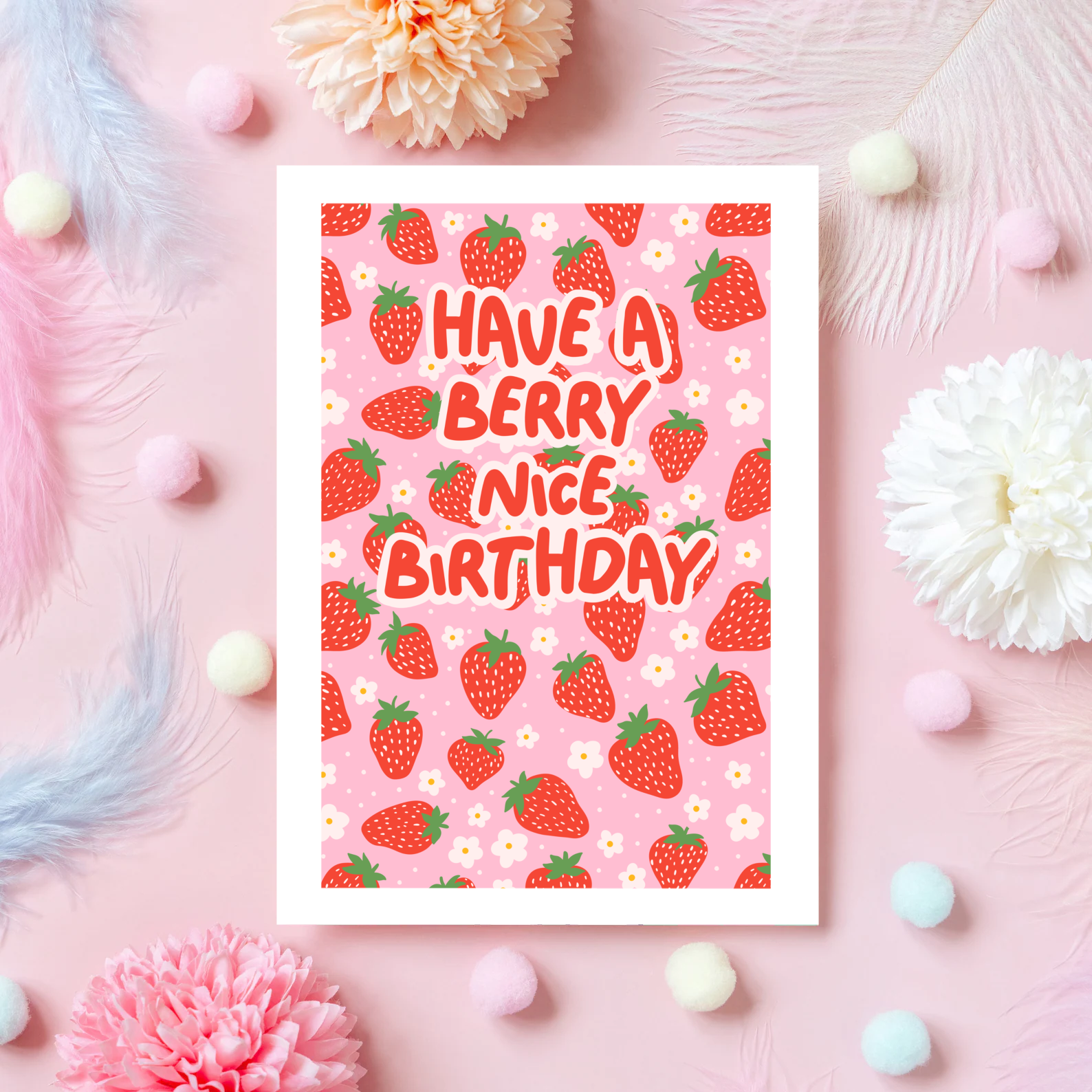 A pink and red card, with a strawberry pattern, and text saying 'have a berry nice birthday'.