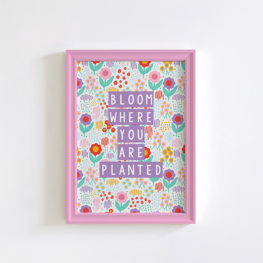 A colourful illustration of a floral background with purple text saying bloom where you are planted.