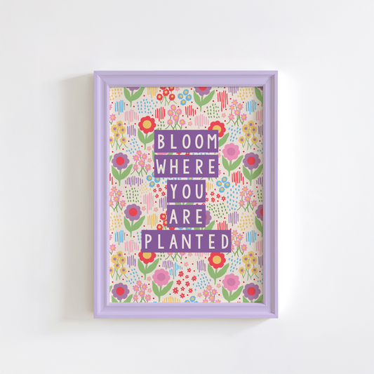 A colourful illustration of a floral background with purple text saying bloom where you are planted.