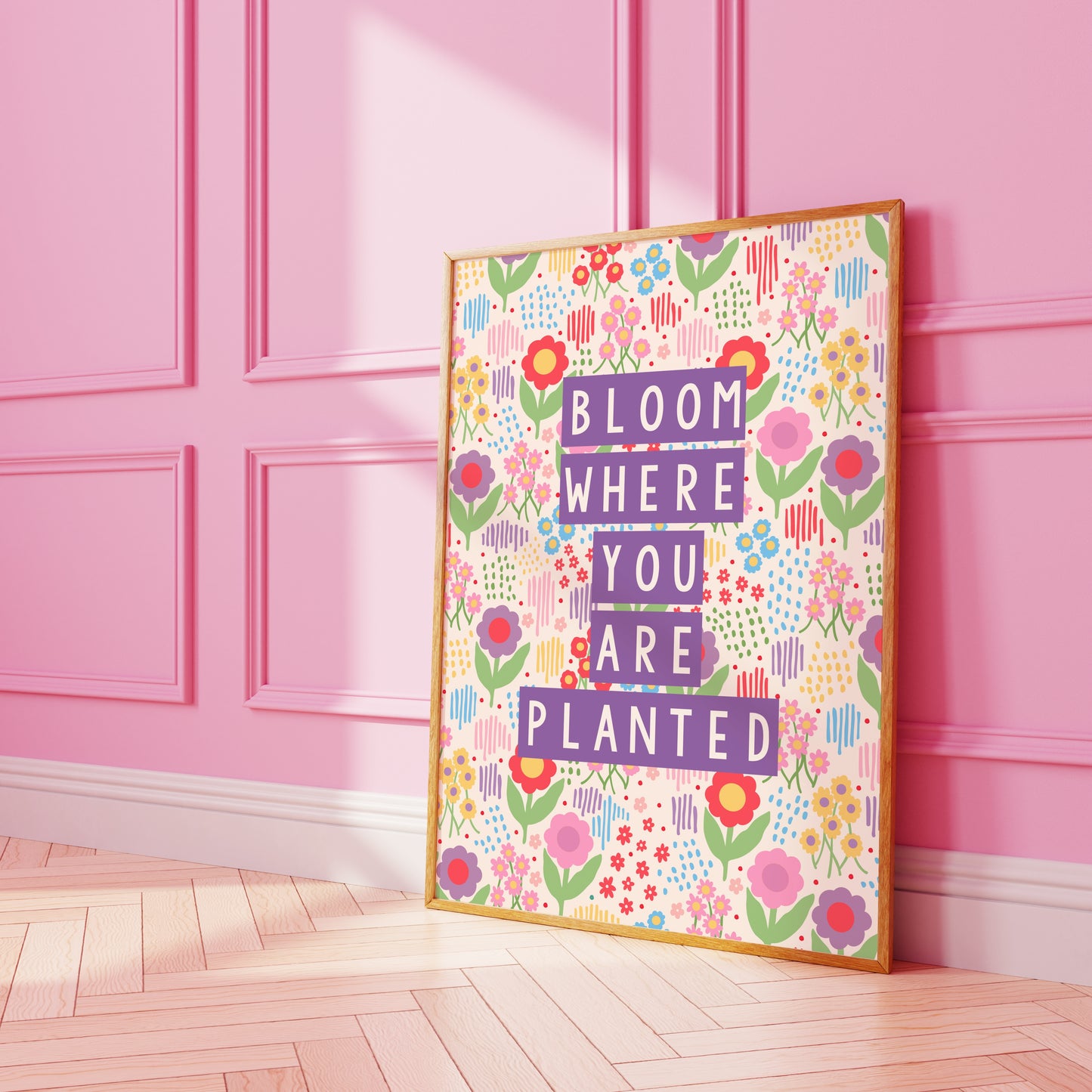 A colourful illustration of a floral background with purple text saying bloom where you are planted.