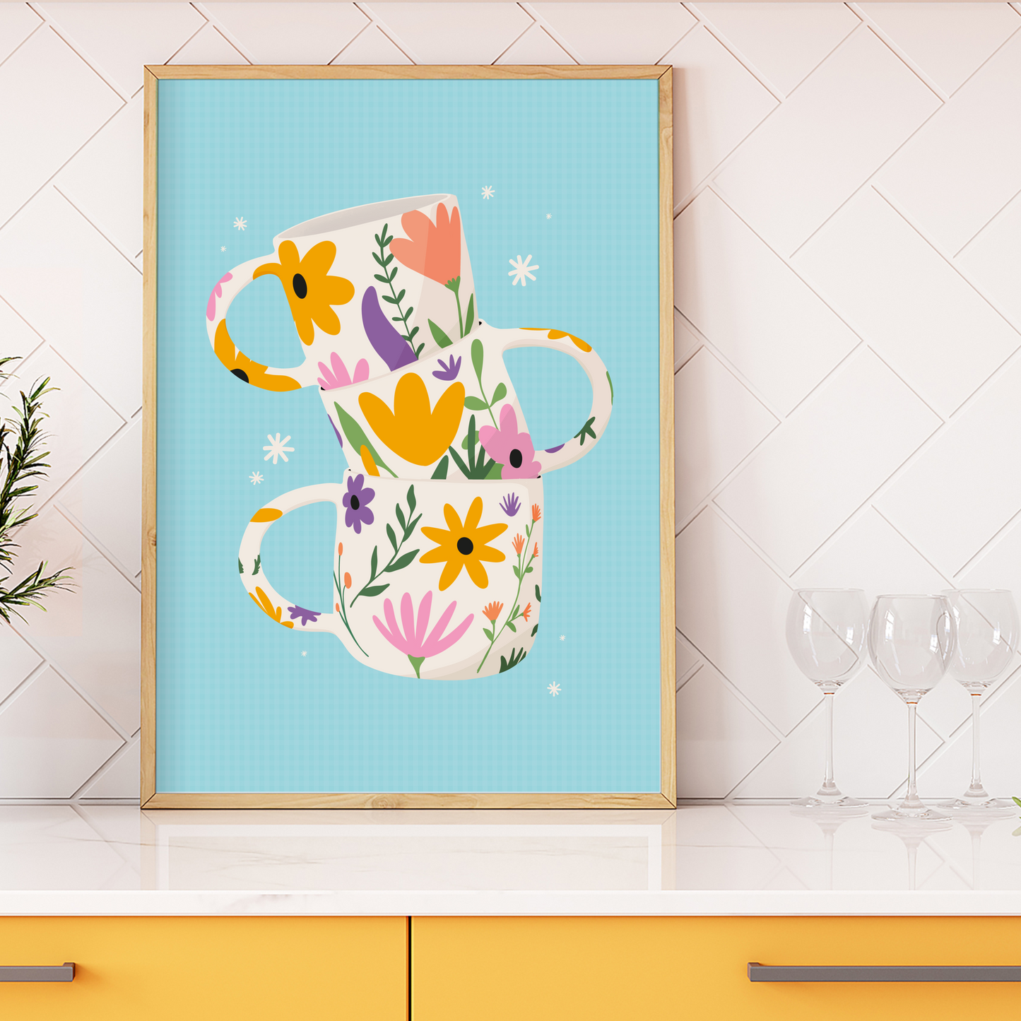 A colourful illustration print with three floral mugs, on a blue background, shown in a frame.