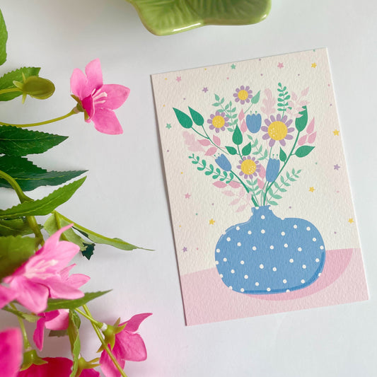 A textured postcard, featuring a blue vase with multicoloured flowers in it.