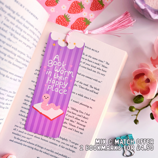 Bookmark with text and illustration on a book, surrounded by flowers and strawberry-themed items.