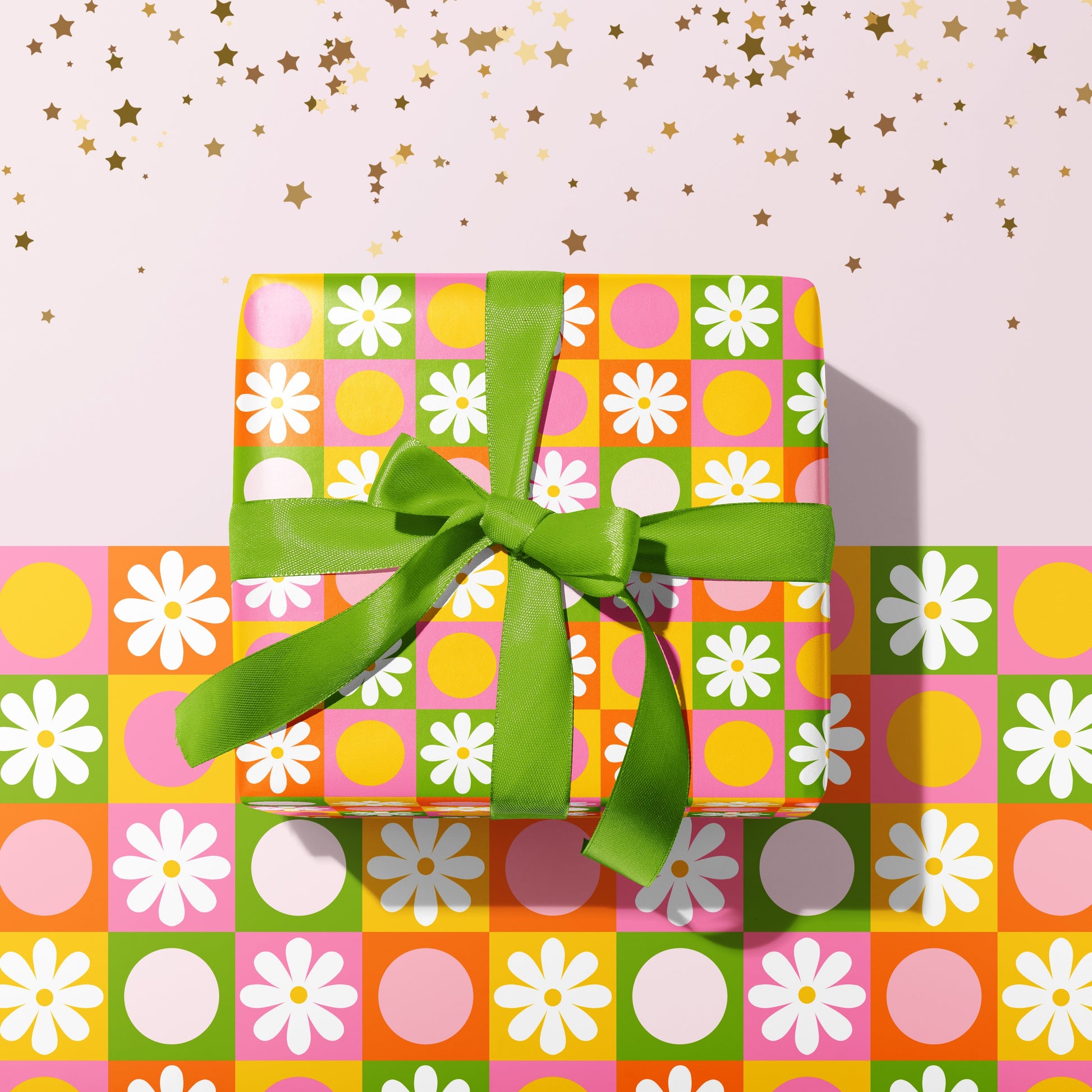 A gift wrapped present, wrapped up in a bright retro print gift wrap from The Happy Badger.