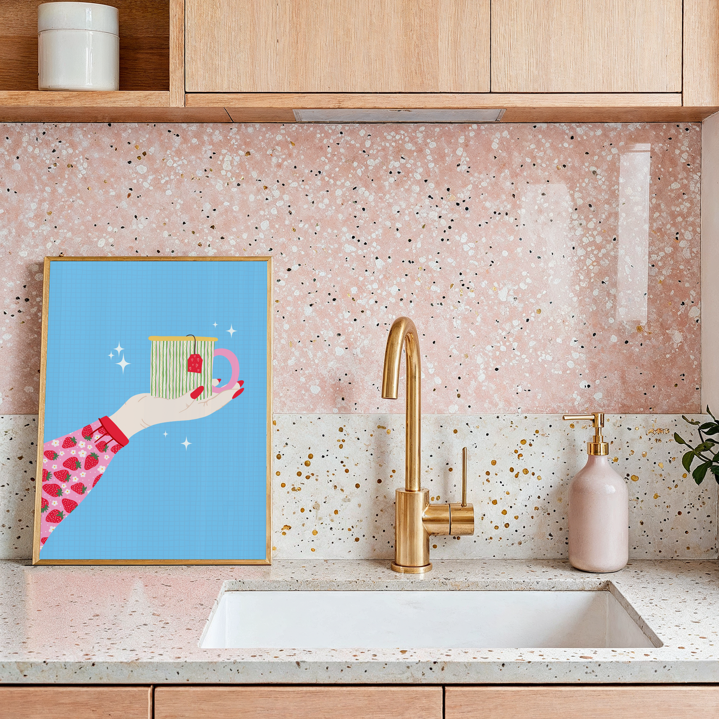 A blue print with an illustration of an arm, wearing a strawberry patterned blouse/top, reaching out into the centre of the frame and holding a brightly coloured mug.