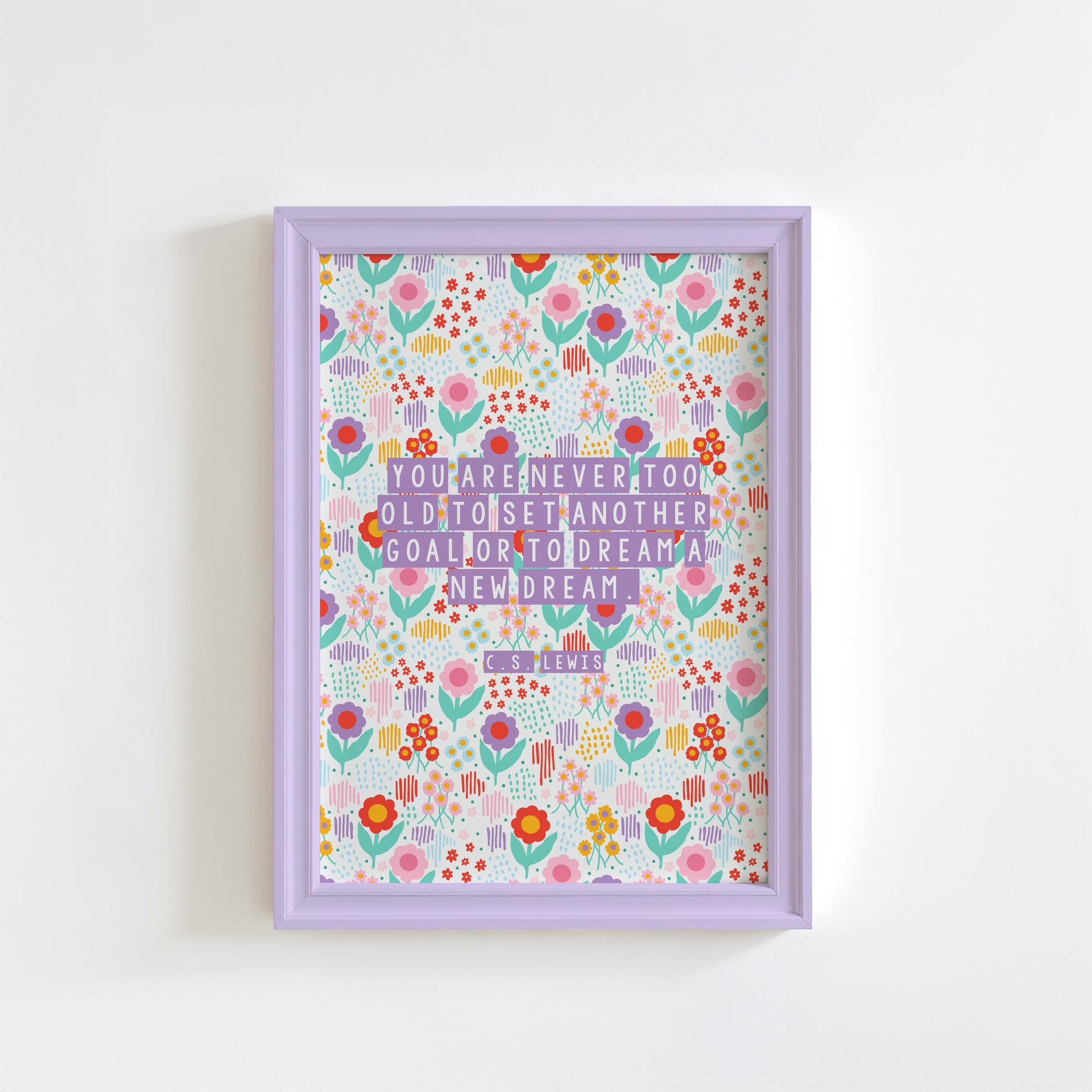 A brightly coloured floral print, with a motivational quote on the front by C.S. Lewis, stating you are never too old to set another goal or to dream a new dream.