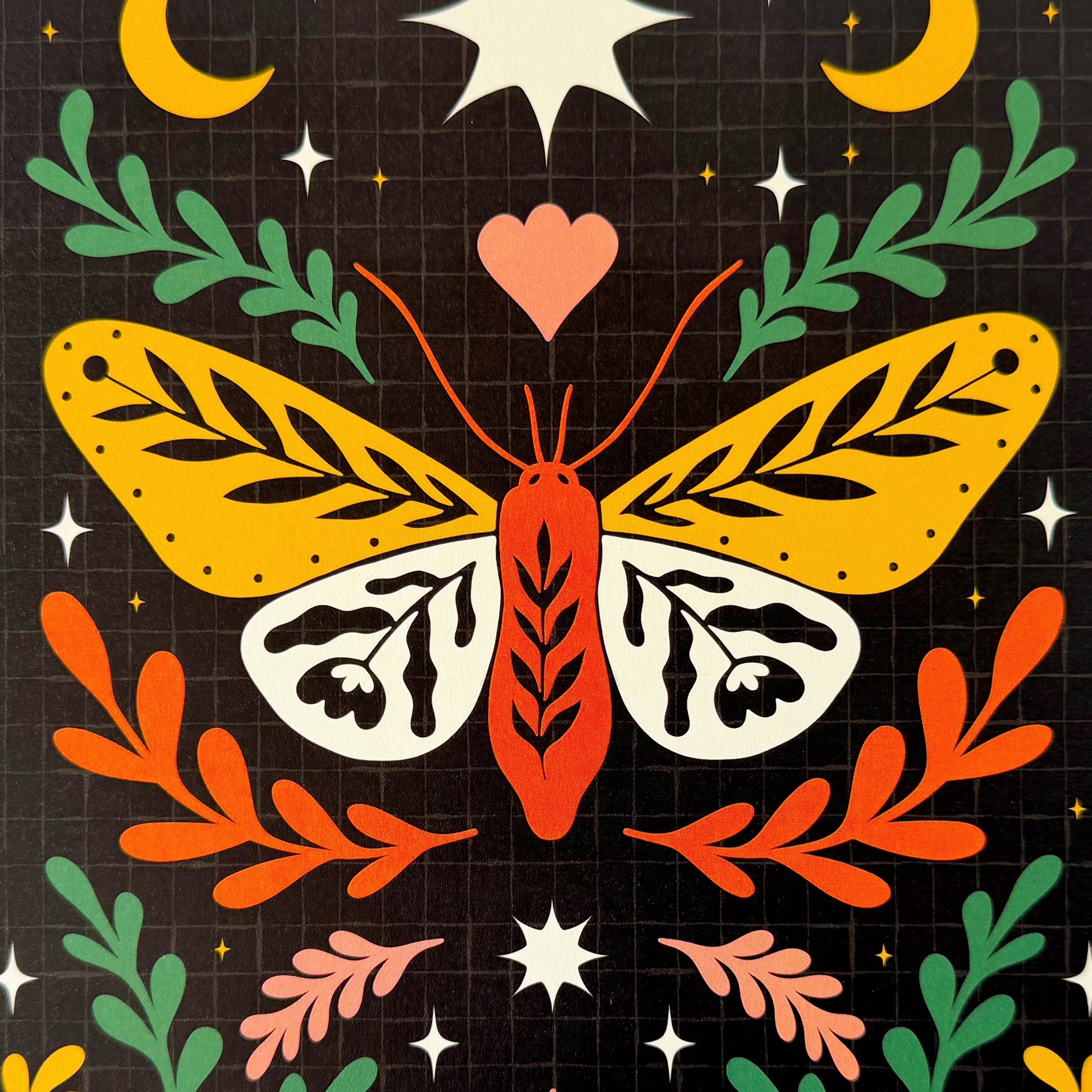 A close up of a dark celestial print, with an illustration of a moth on.
