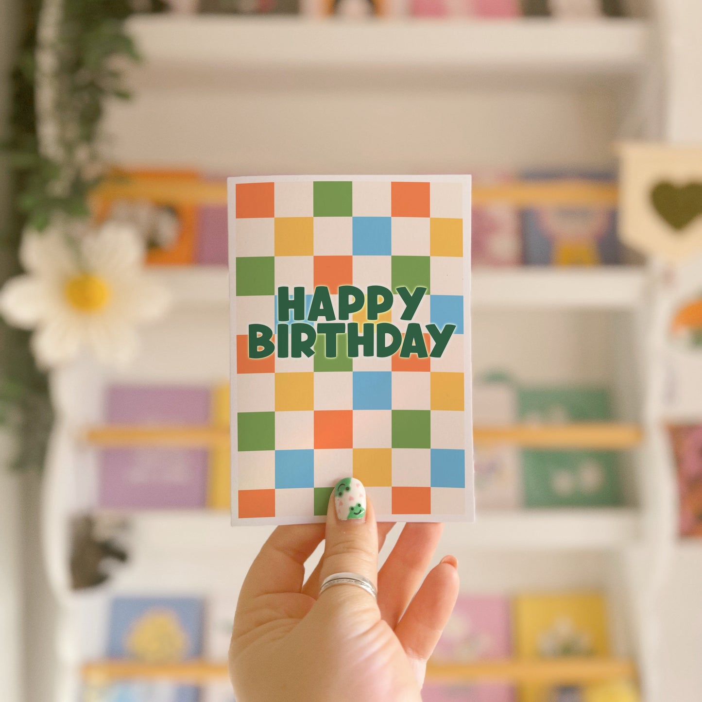 Happy Birthday card with a colourful checkered background. 