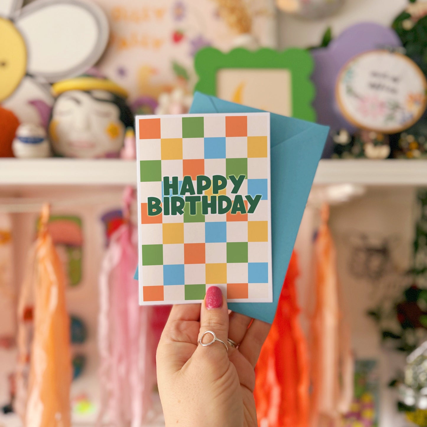 Happy Birthday card with a colourful checkered background. 