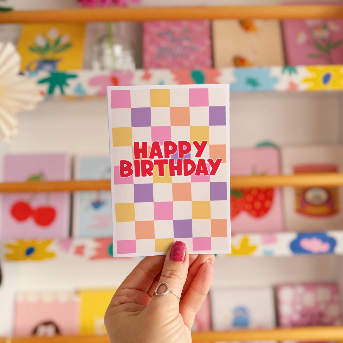 Happy Birthday card with a colourful checkered background. 