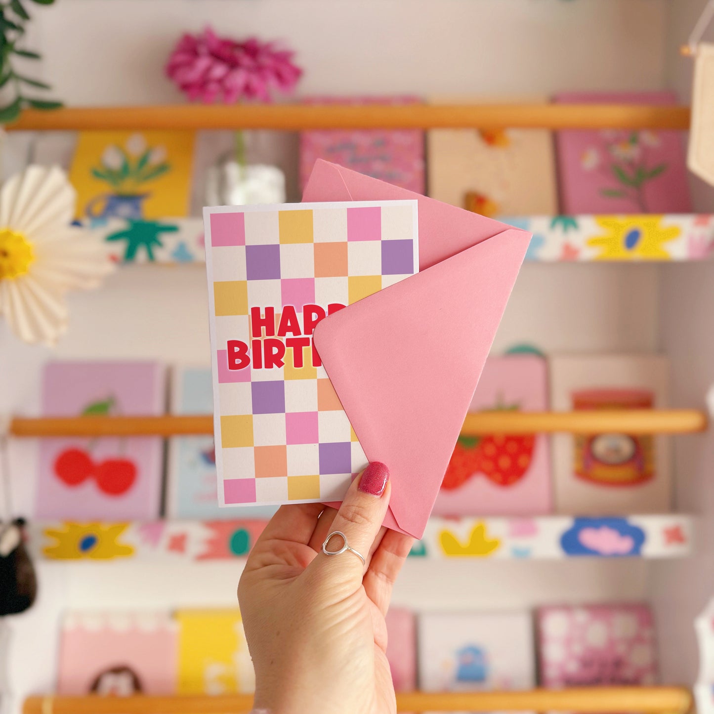 Happy Birthday card with a colourful checkered background. 