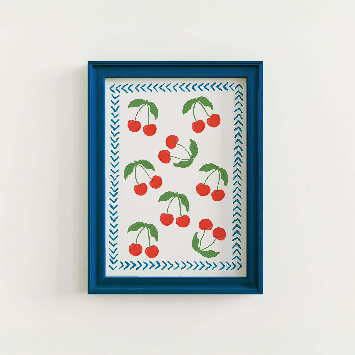 A print with red cherries all over it, and a blue chevron border, on a white background.