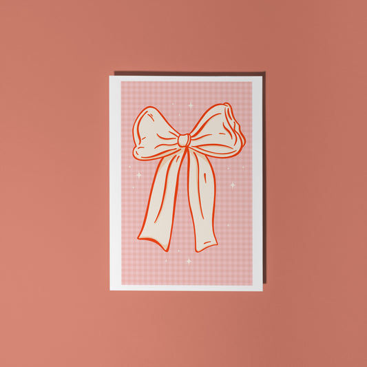 Card with a bow design on a pink background