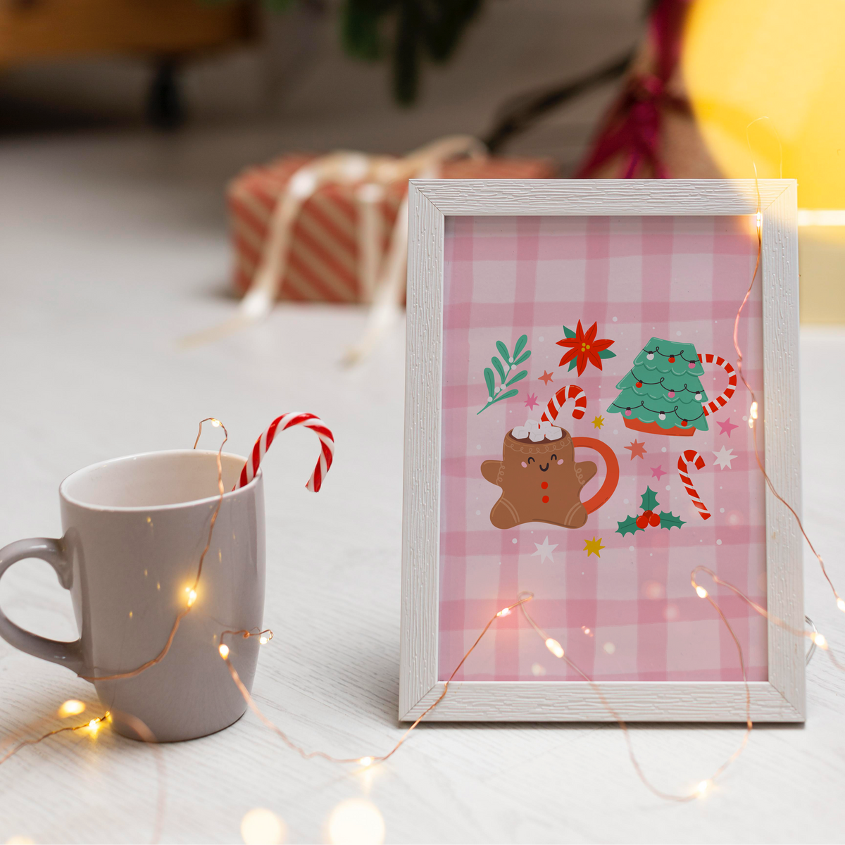 An illustrated Christmas print featuring two Christmas mugs - one a gingerbread person, and one a Christmas tree shaped mug. The mugs are surrounded by Christmas themed doodles.