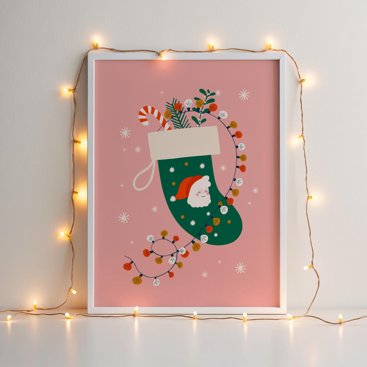 A Christmas illustration print featuring a green traditional stocking with a Father Christmas design, with fairly lights, candy canes and mistletoe inside the stocking.
