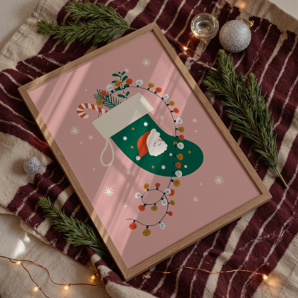 A Christmas illustration print featuring a green traditional stocking with a Father Christmas design, with fairly lights, candy canes and mistletoe inside the stocking.