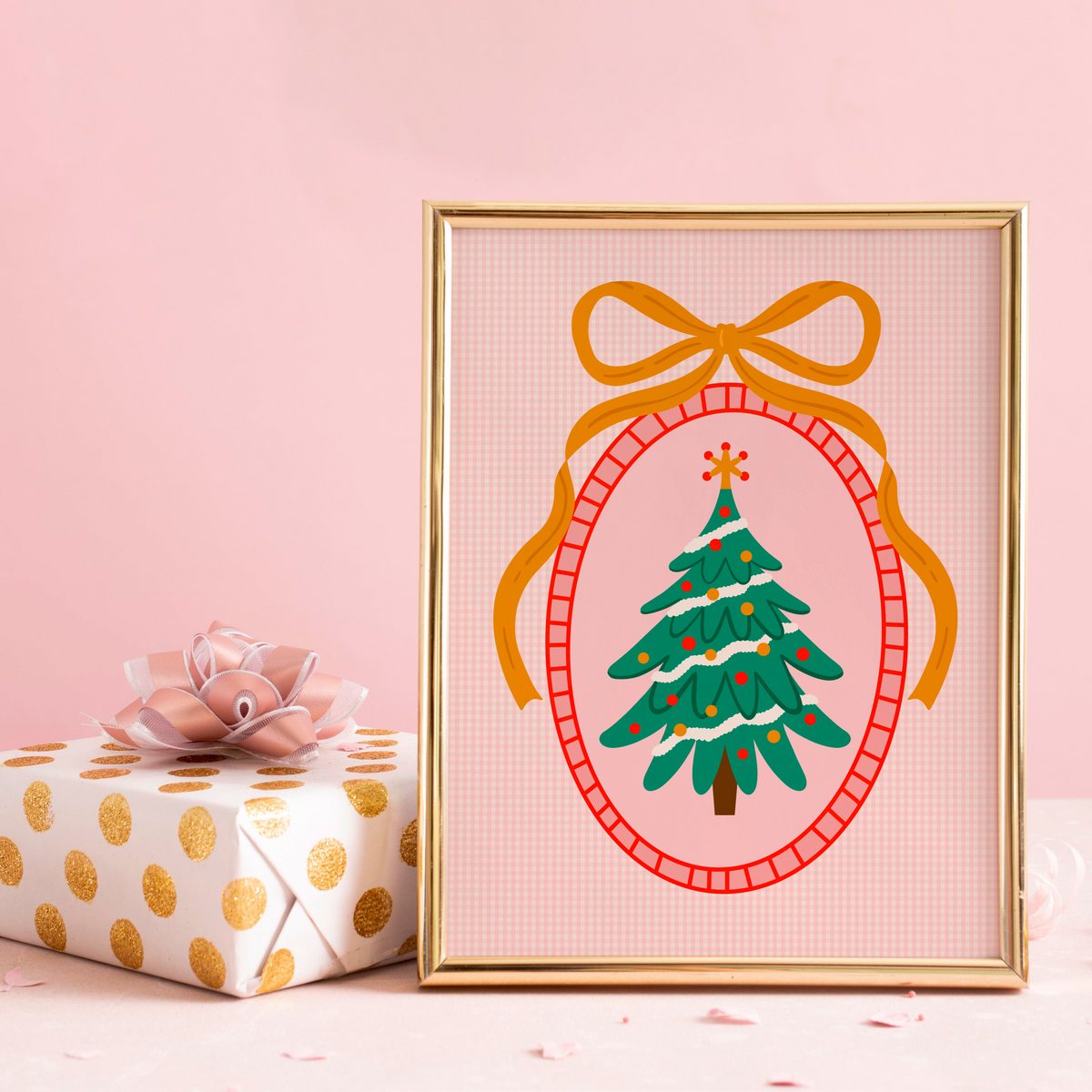 An illustration of a Christmas tree, surrounded by a hand drawn border with a large golden bow on top. The background of the print is a warm pink gingham.