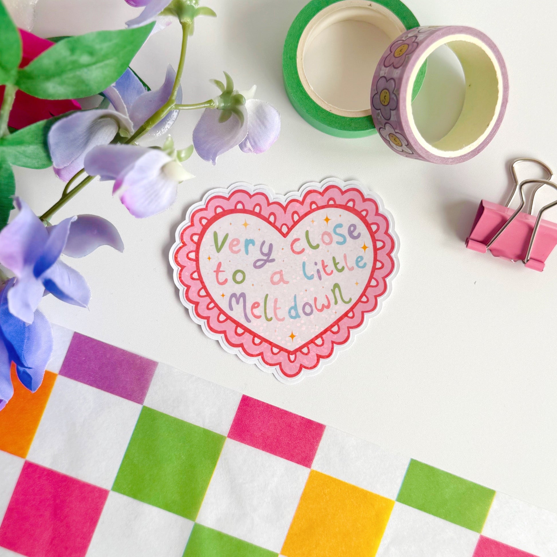 A scalloped edge heart, with hand lettered quote in the centre that reads 'very close to a little meltdown'.