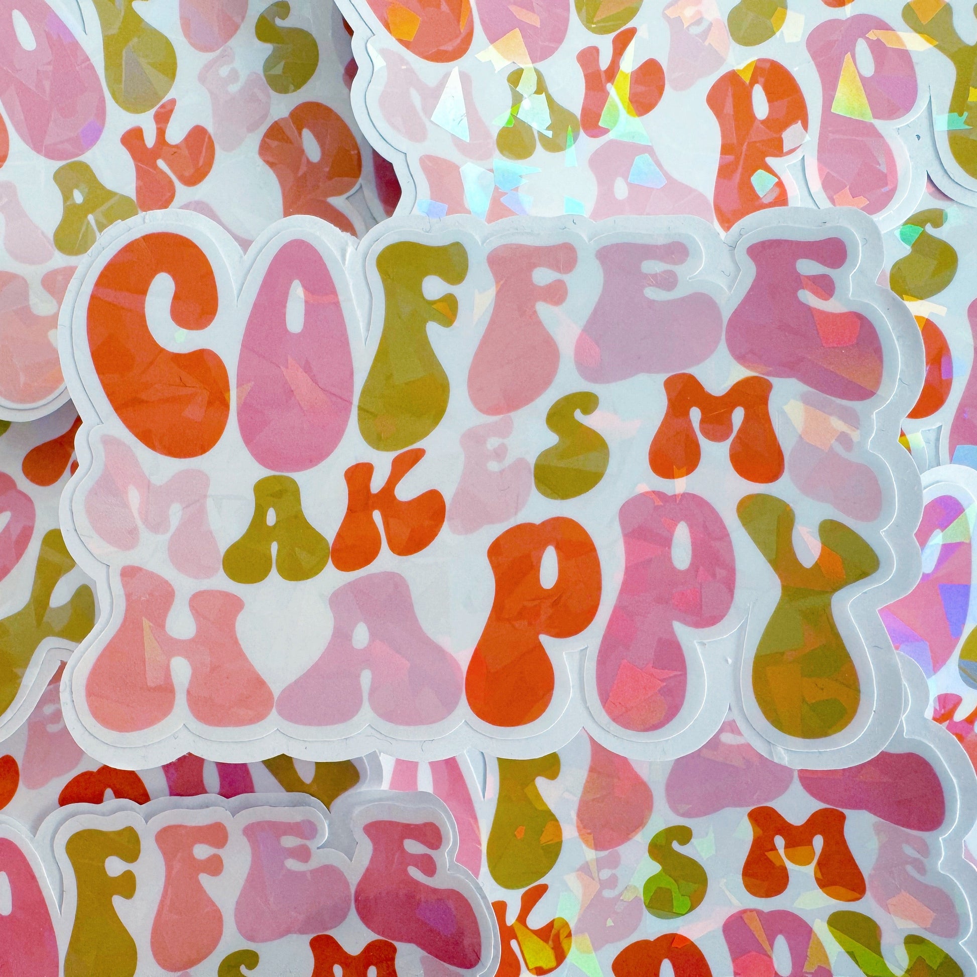 A holographic sticker, of the words coffee makes me happy in bubble writing. The sticker has an easy peel lip.