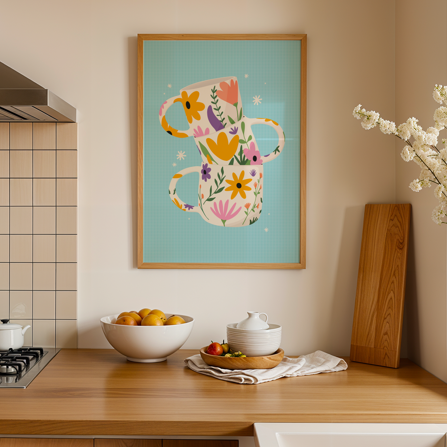 A colourful illustration print with three floral mugs, on a blue background, shown in a frame.