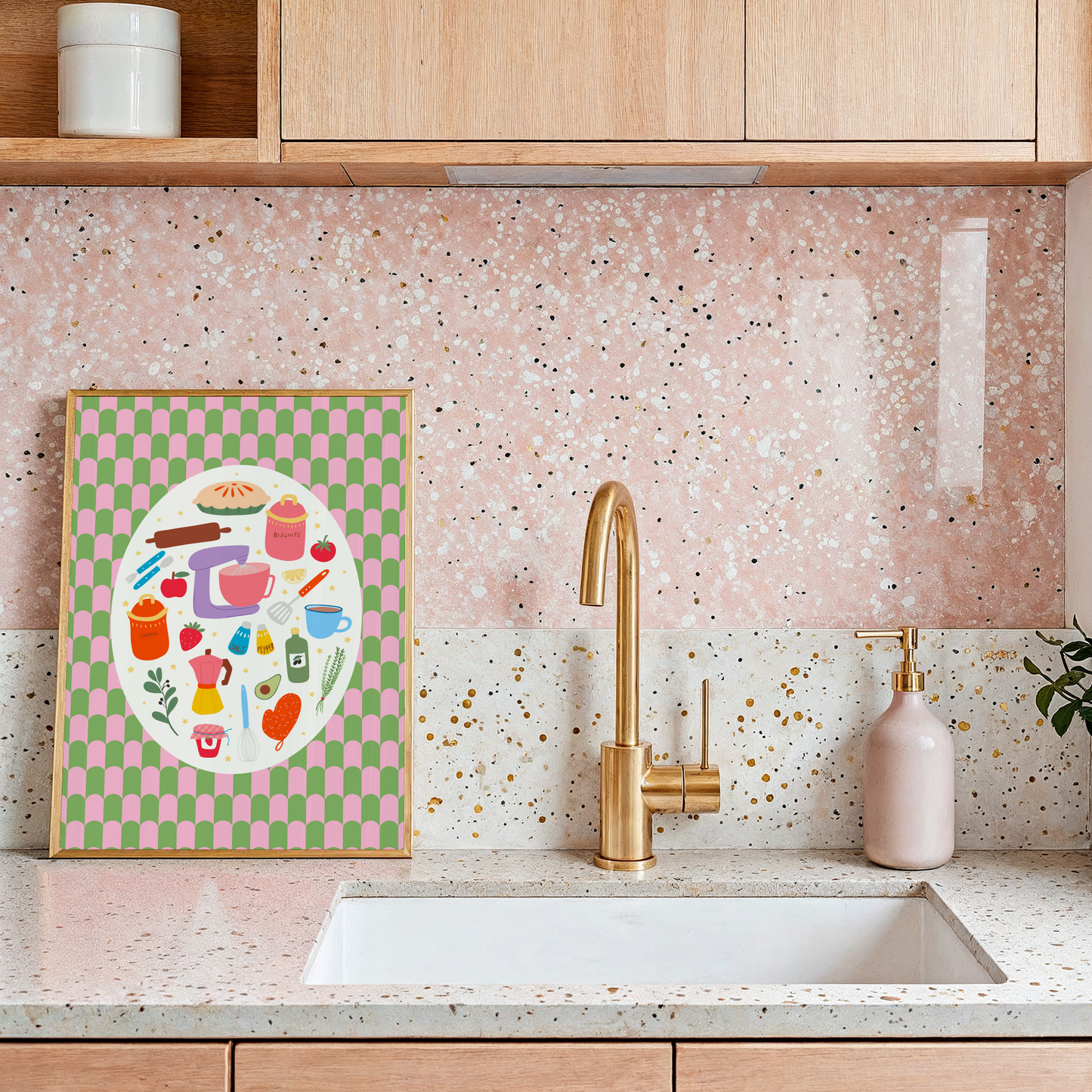 A bright print with a green and pink patterned background, with a cream oval in the centre. Inside the oval are lots of different kitchen themed illustrations, like food and utensils.