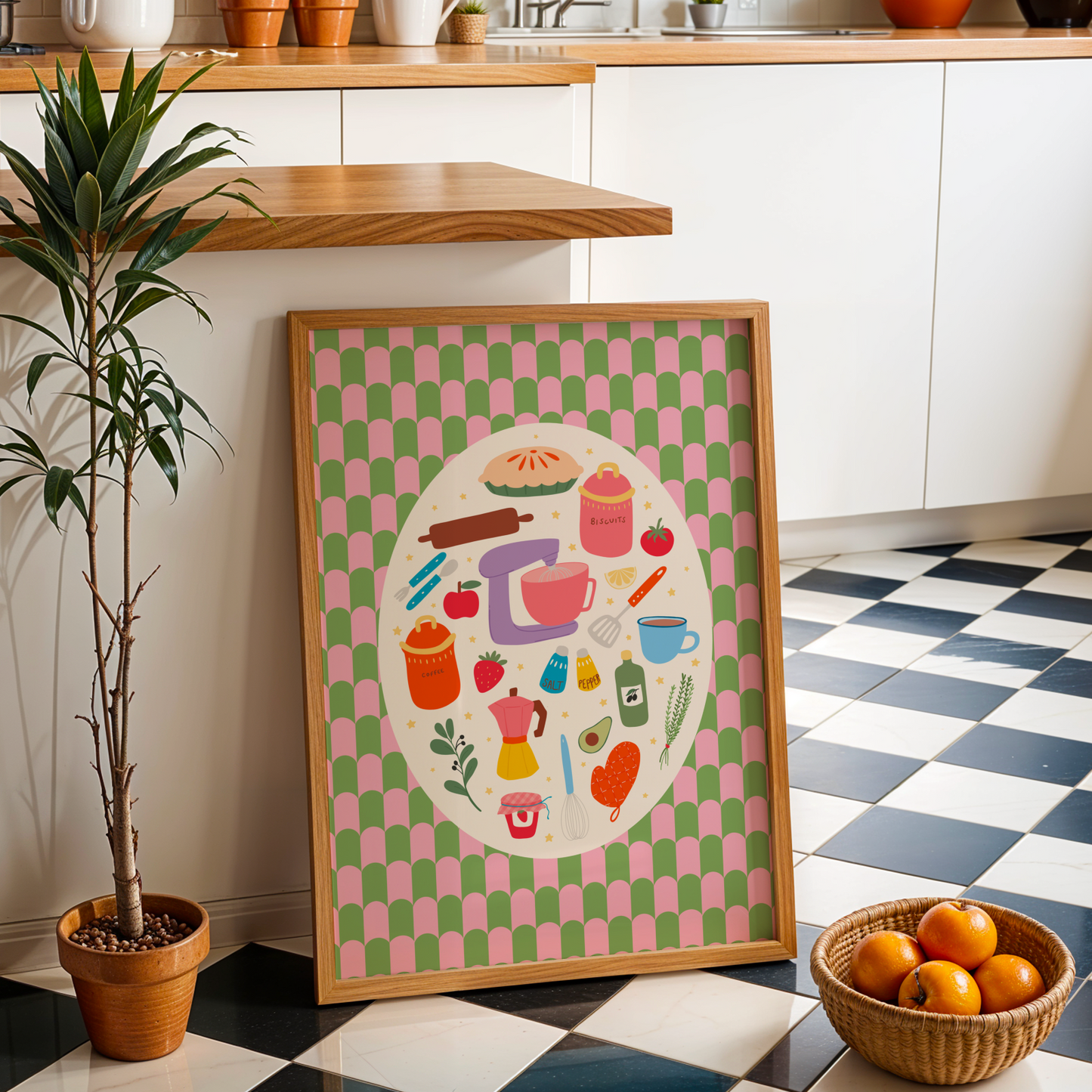 A bright print with a green and pink patterned background, with a cream oval in the centre. Inside the oval are lots of different kitchen themed illustrations, like food and utensils.