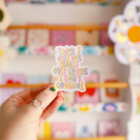 A holographic sticker, with the quote today I will not stress over things I can't control on it. The sticker has an easy peel lip.