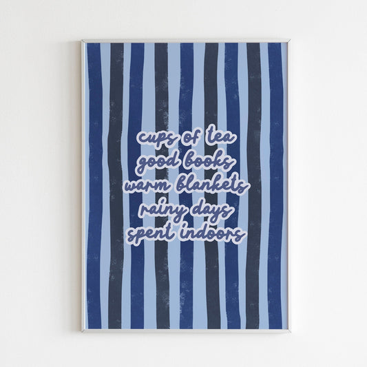 An cosy autumn quote print, on a blue striped background, shown in a frame.