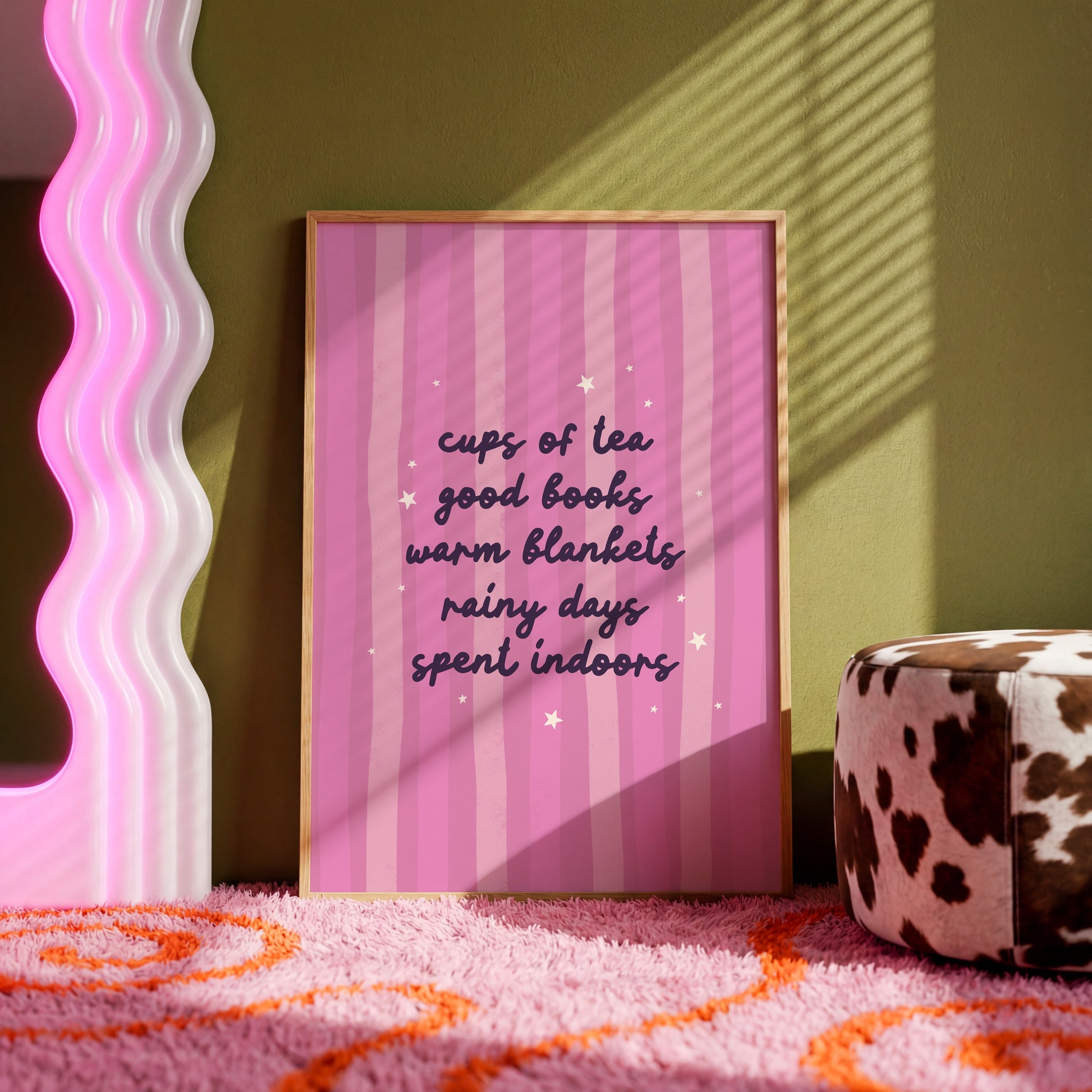 A purple striped background with a cosy quote about what makes a perfect cosy day indoors (tea, books, blankets and rain!)