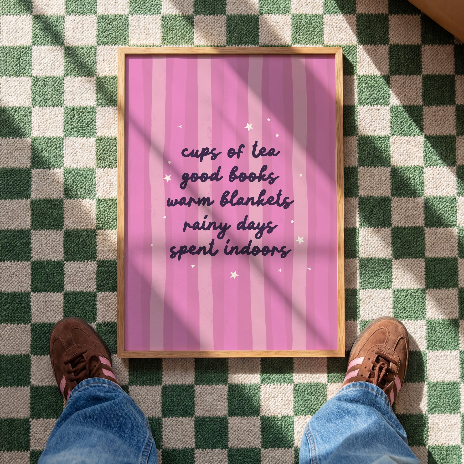A purple striped background with a cosy quote about what makes a perfect cosy day indoors (tea, books, blankets and rain!)