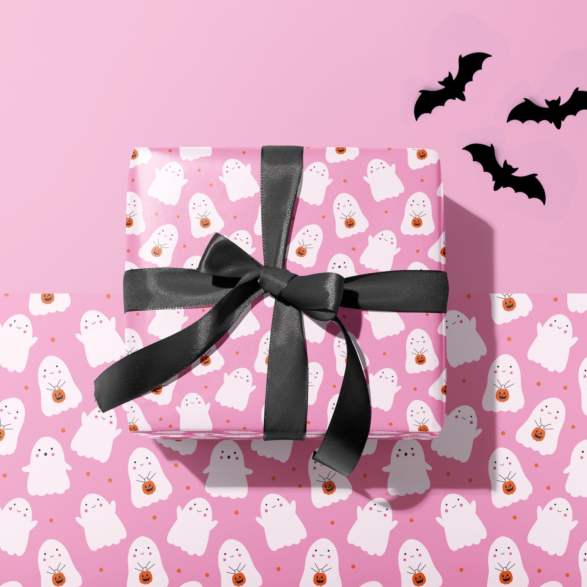 A gift wrapped present, wrapped up in a cute halloween themed print gift wrap from The Happy Badger.