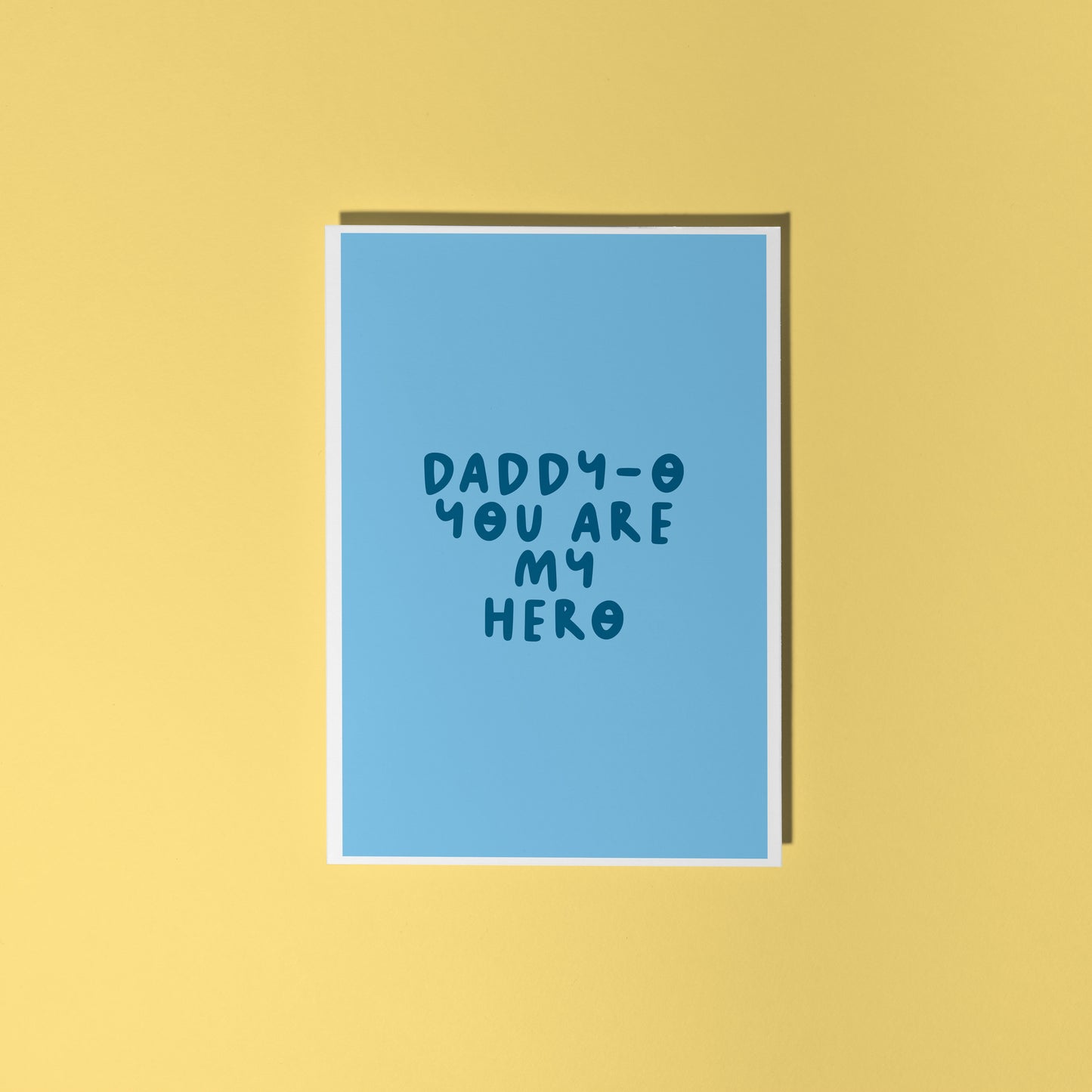 A blue greeting card with text that reads 'daddy-o you are my hero'.